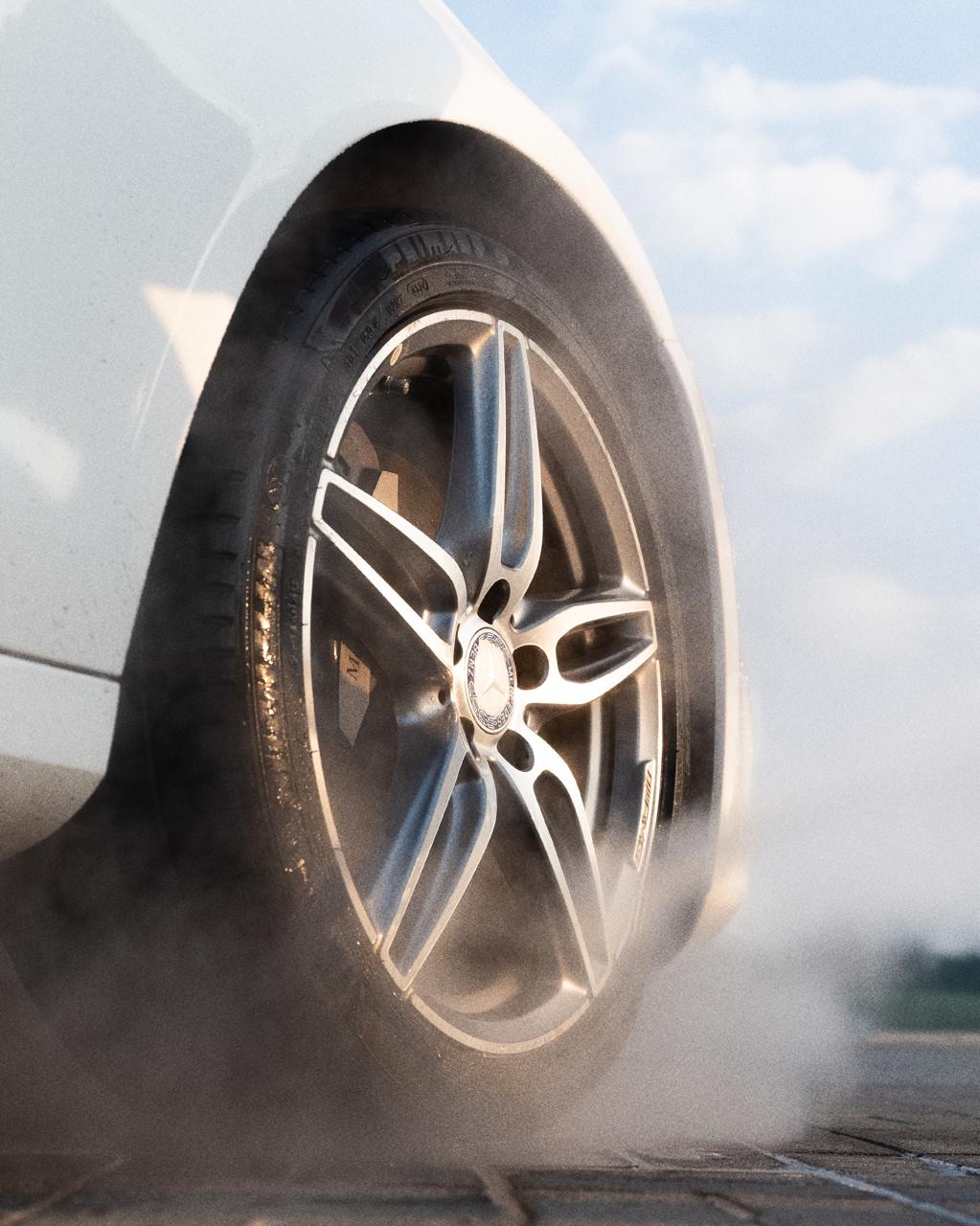 Detailed Mercedes alloy wheel in golden-hour light